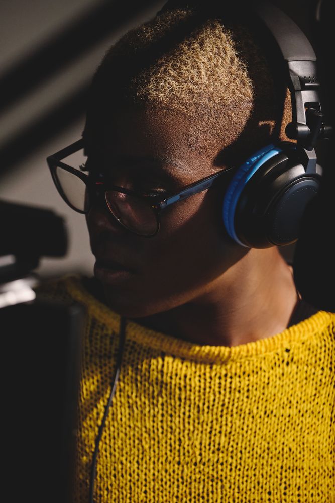 Focused Black female singer in headset