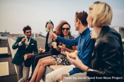 Young men and women having drinks on rooftop 5r3L34