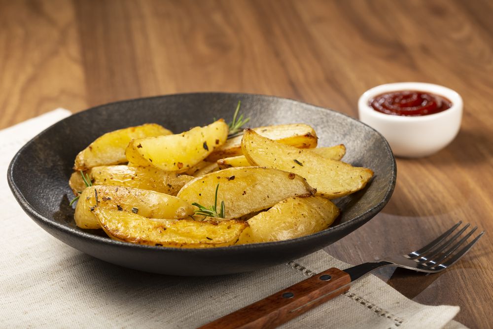 Roasted potatoes with rosemary on the plate.