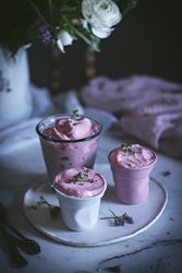 tasty glasses of strawberry mousse on a table with flowers