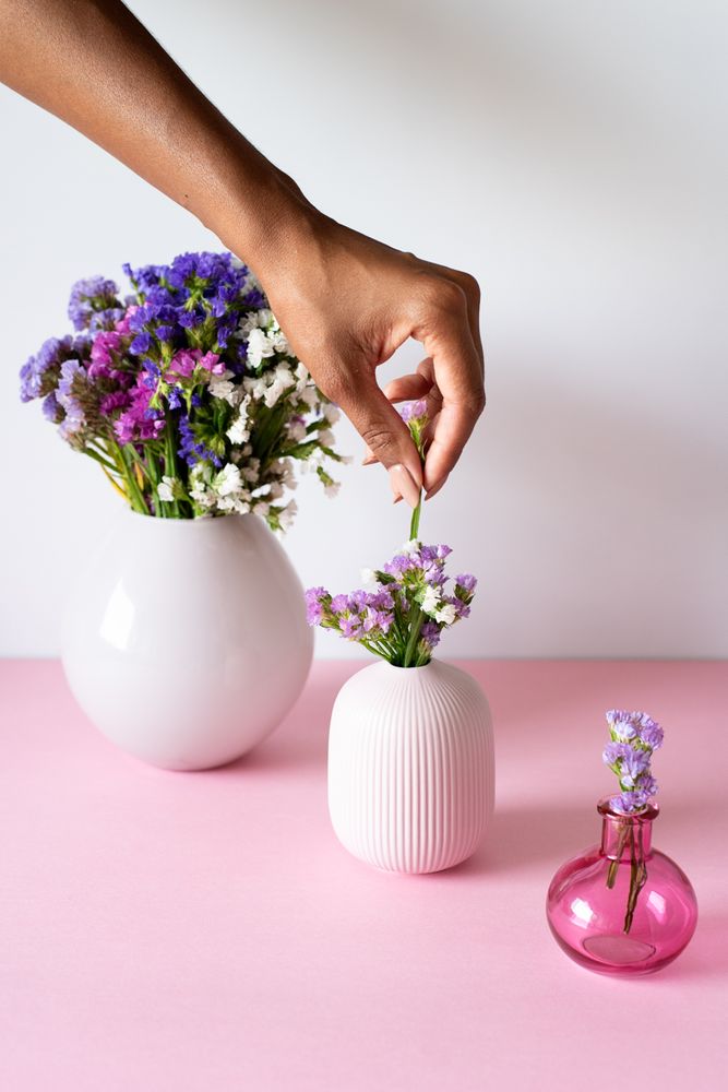 Hand fixing a bouquet of sea lavender flowers