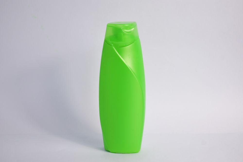 Green body wash bottle without labels and copy space