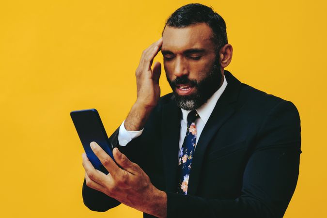 Frustrated Black businessman having a video call on a smartphone screen