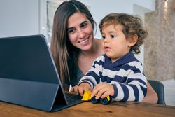 Mother and son and using laptop at home
