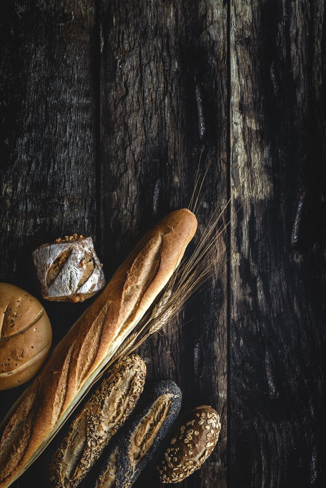 Assorted gold homemade bread on dark wood background