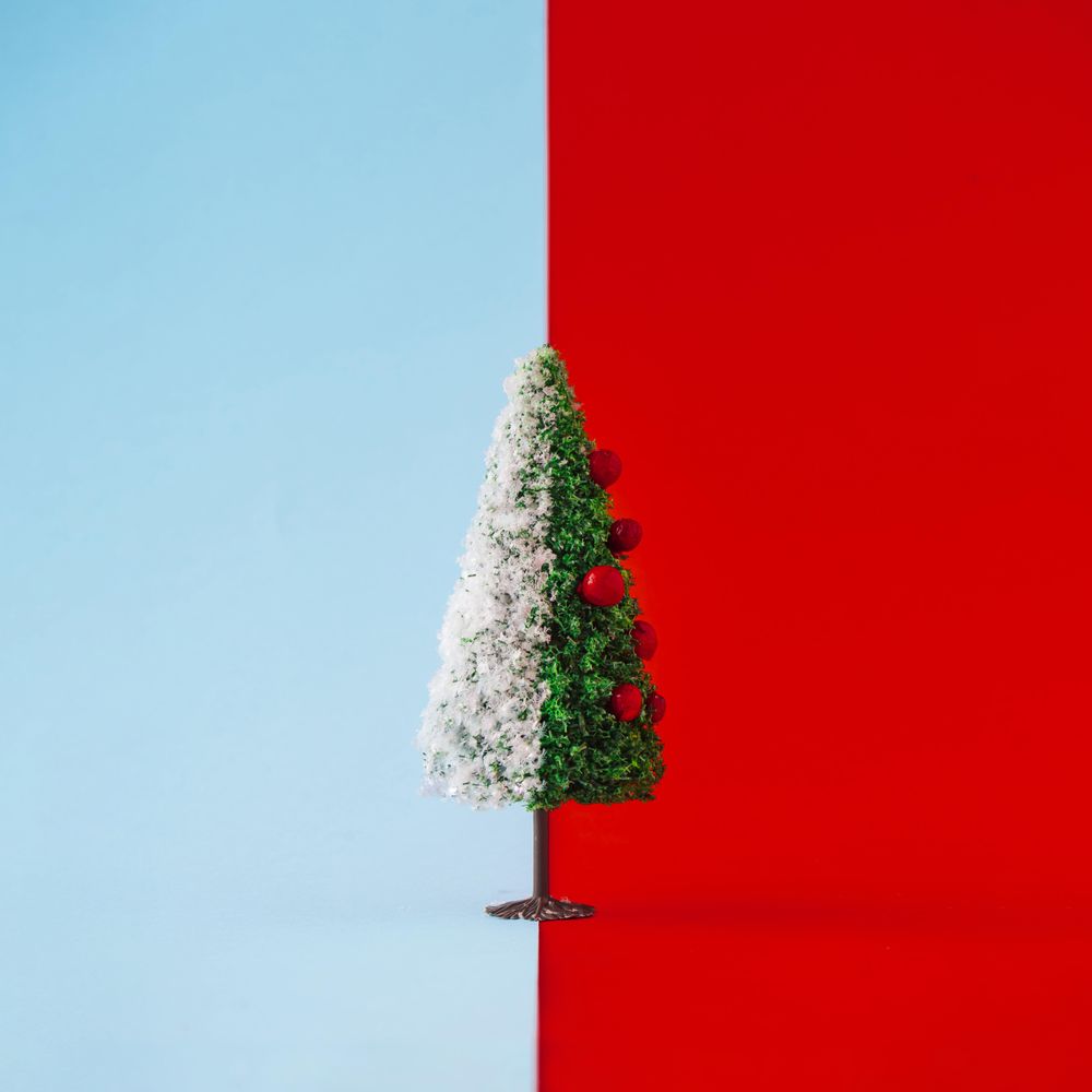 Decorated Christmas tree half with snow on duotone background