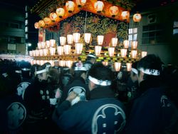 Japanese men parading at night