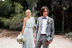 Happy married couple in wedding clothing at forest
