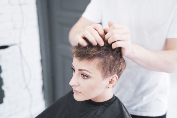Hairdresser combing the woman's fingers