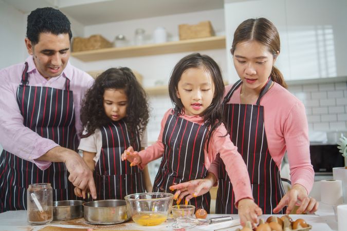 Asian family baking treats together in the kitchen