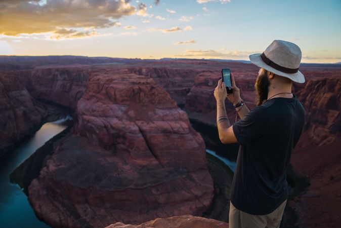 Traveler taking picture near canyon