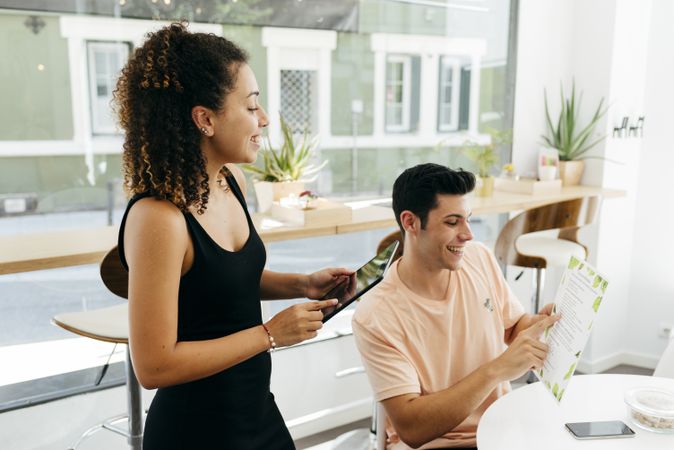 Friends making order in modern cafe