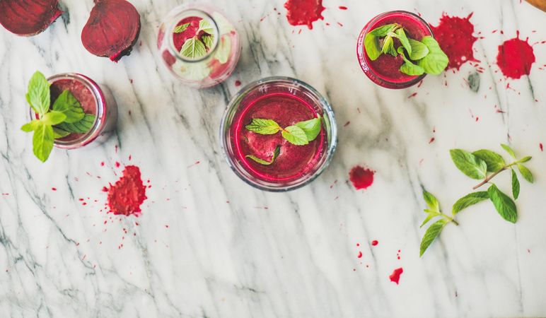 Top view of fresh beet juice in glasses garnished with mint