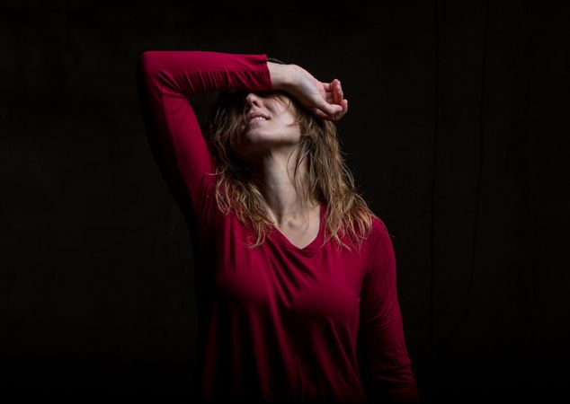 Young woman dancing in darkness