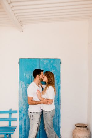 Loving couple cuddling near beach house