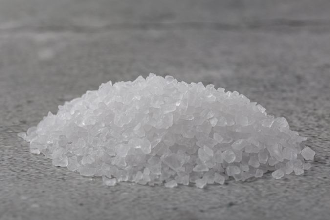 Handful of coarse salt on the table.