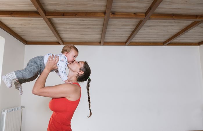 Woman kissing baby in gym