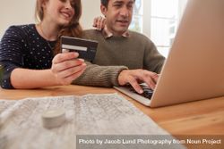 Young couple at home shopping online with credit card 5zrwPm