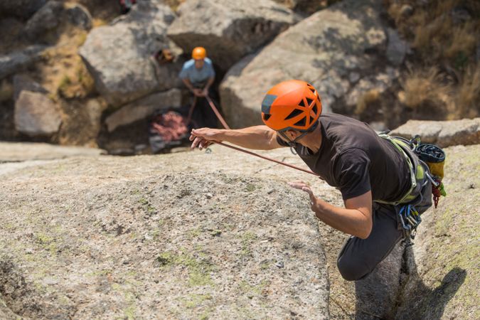 Climbers in safety harness climbing mountain