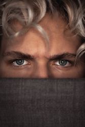 Young man's angry blue eyes