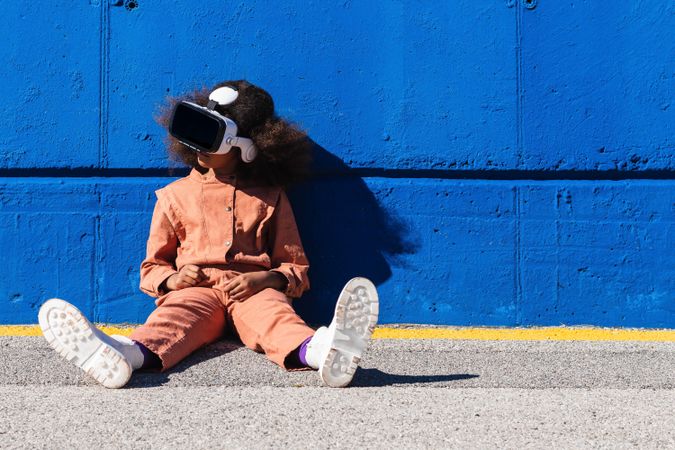 Black teenager in VR headset exploring cyberspace
