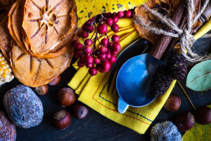 Seasonal autumn flatlay with nuts, berries, vegetable and fruits on dark wooden table