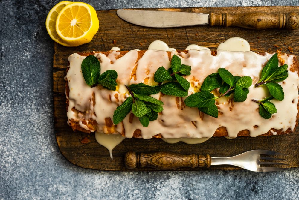 Top view of freshly baked lemon cake dessert on wooden board