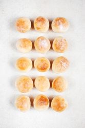 Freshly baked bread rolls in neat rows