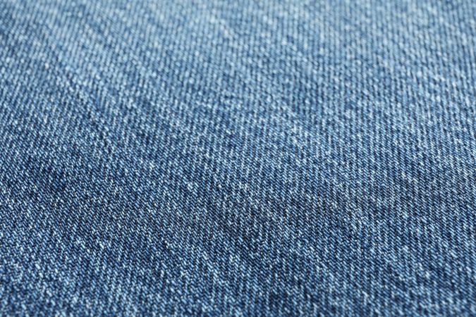 Texture of blue jeans as background, space for text