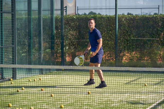 Sportsman playing padel on playground