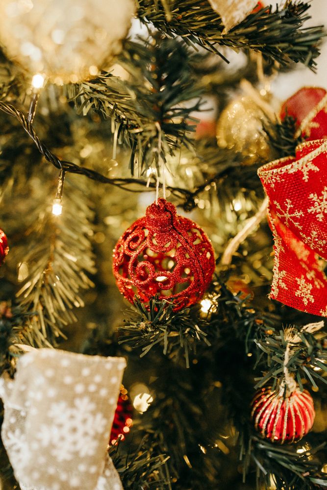 Red bauble and ornaments on Christmas tree in close-up