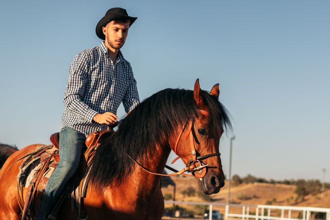 Man riding a horse in an equestrian center