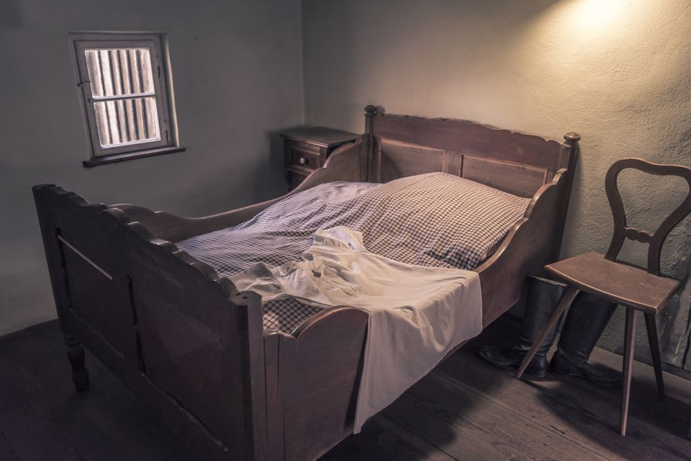 Vintage bedroom with wooden bed and chair