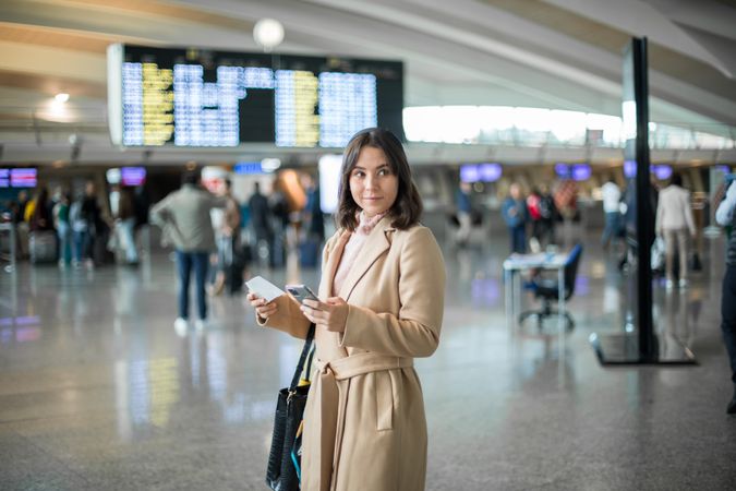 Woman using smartphone at airport