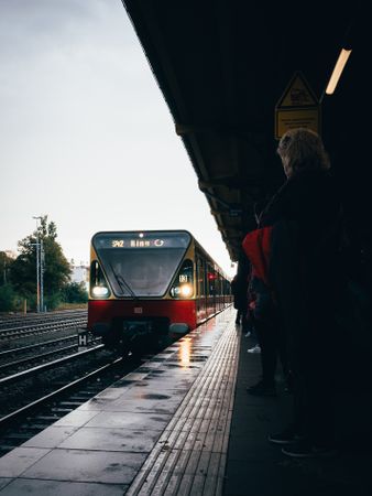 People waiting for the train to stop at trainstation