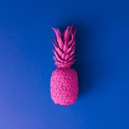 Pineapple in vibrant bold gradient holographic neon  colors on blue background