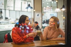 Multiethnic friends talking in cafe