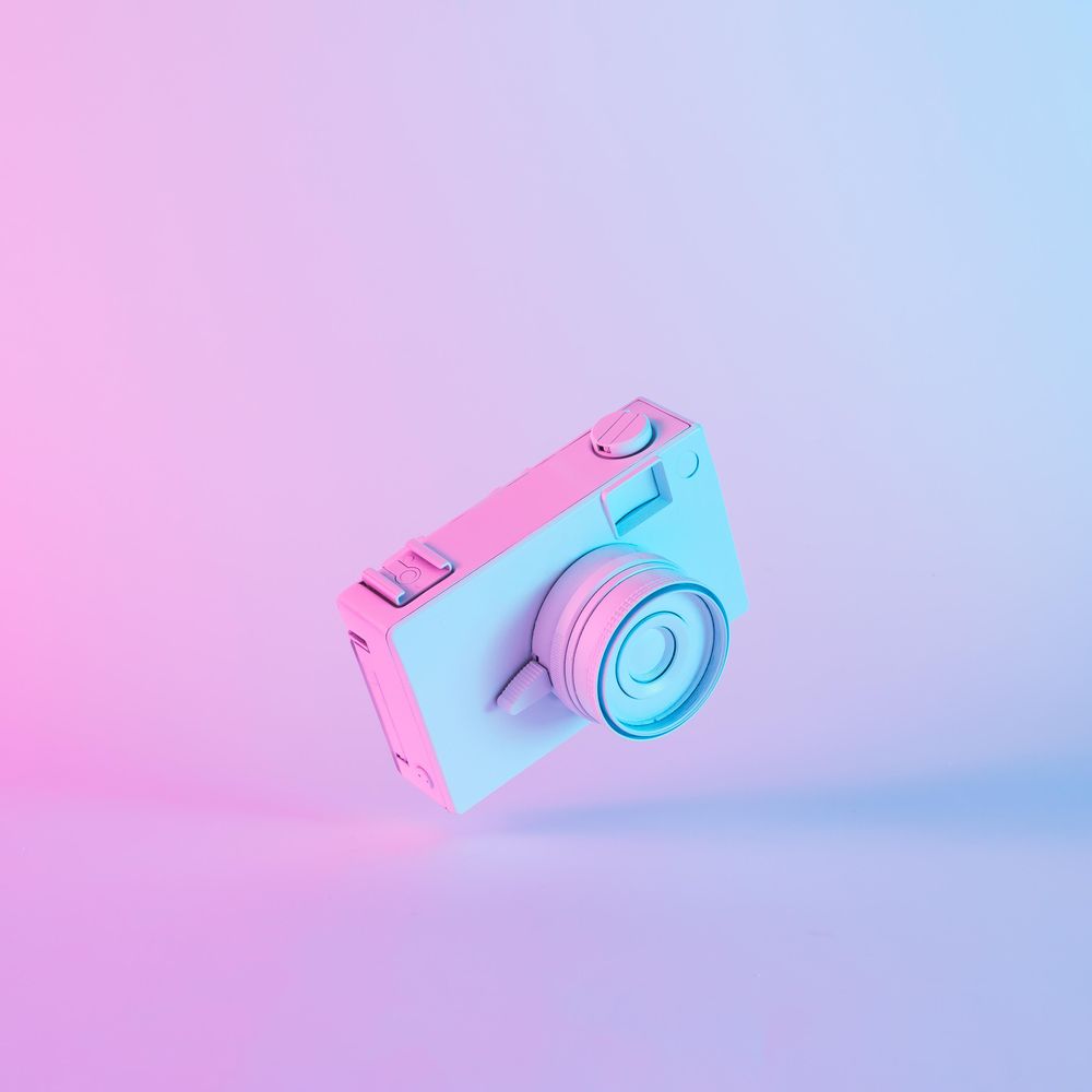 Vintage camera in vibrant bold gradient purple and blue holographic colors