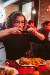 Young woman taking photo of food