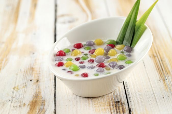 Thai dessert of colorful rice balls in sweet coconut milk