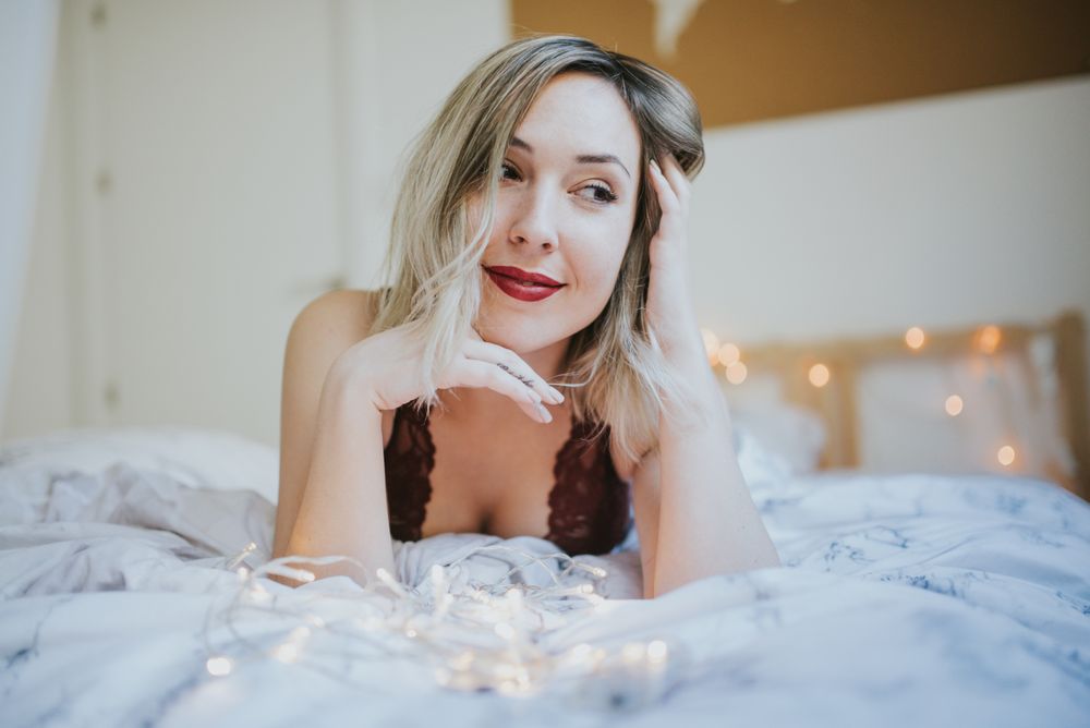 Woman lying in bed at home