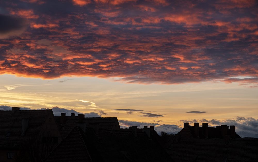 Pink clouds over the last light in the sky before sunset