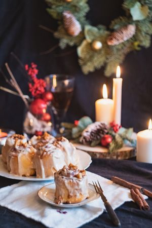 Warm Christmas buns on table with candles