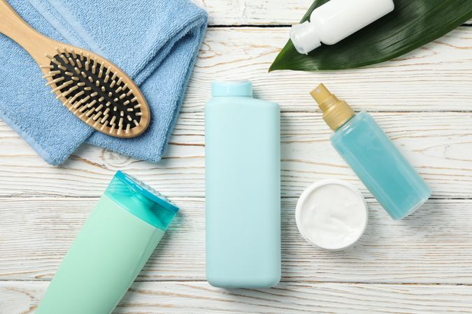 Composition with body care products on wooden background, top view