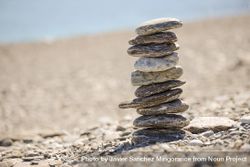 Pebbles balancing on the sandy beach 0vvPd0