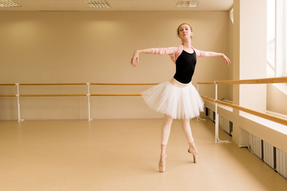 Ballet dancer gracefully performs a pose on pointe