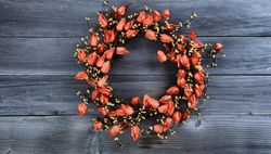 Autumn orange wreath on vintage wooden boards