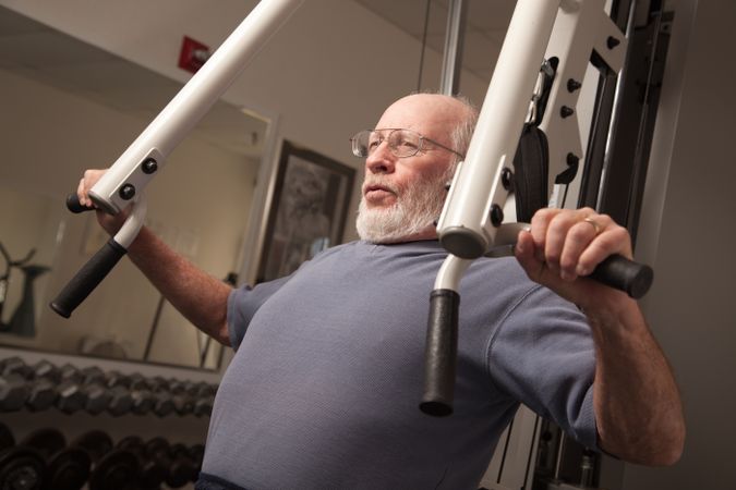Mature Adult Man Working Out in the Gym.