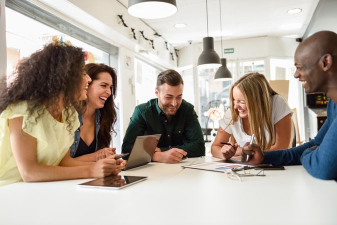 Group of people meeting around a table to go through statistics for work