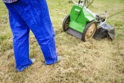 man mowing the lawn with a lawnmower